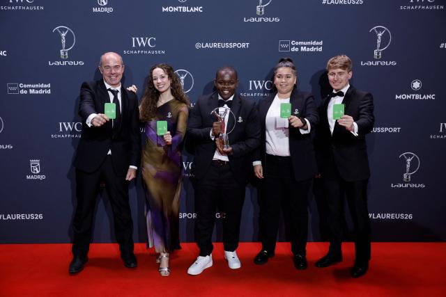 Members of 'Futbol Mas' program, promoting inclusivity and mental wellbeing in young people, pose with the Sport for Good Award during the 27th Laureus World Sports Awards gala in Madrid on April 20, 2026. (Photo by Oscar DEL POZO / AFP)