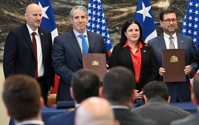 (L to R) US Ambassador to Chile Brandon Judd, US Under Secretary of State for Arms Control and International Security Thomas DiNanno, Chile's Minister of Public Security Trinidad Steinert and Chile's Foreign Minister Francisco Perez Mackenna pose with agreements signed by Chile and the United States on mining and security in Santiago on April 20, 2026. (Photo by RODRIGO ARANGUA / AFP)