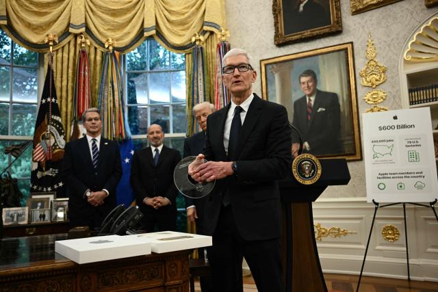 (FILES) Apple CEO Tim Cook speaks as US President Donald Trump (2nd R), Commerce Secretary Howard Lutnick (2nd L) and Treasury Secretary Scott Bessent (L) look on in the Oval Office of the White House in Washington, DC, on August 6, 2025 to announce that Apple will invest an additional $100 billion in the United States, taking its total pledge to $600 billion over the next four years. Apple announced on April 20, 2026 that Cook would step down in September, handing the chief executive job to company veteran John Ternus. (Photo by Brendan SMIALOWSKI / AFP)