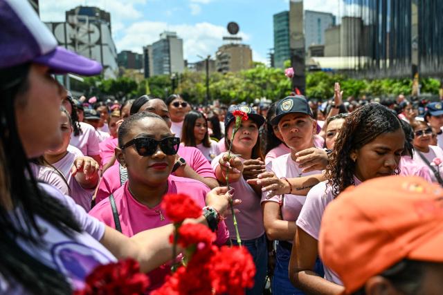 Women supporters of Venezuela’s interim President Delcy Rodriguez take part in a demonstration in Caracas on April 20, 2026, protesting against a rally held by opposition figure Maria Corina Machado in Madrid on April 19, 2026. (Photo by Juan BARRETO / AFP)