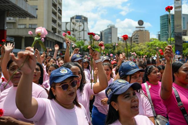 Women supporters of Venezuela’s interim President Delcy Rodriguez shout slogans during a demonstration in Caracas on April 20, 2026, protesting against a rally held by opposition figure Maria Corina Machado in Madrid on April 19, 2026. (Photo by Juan BARRETO / AFP)