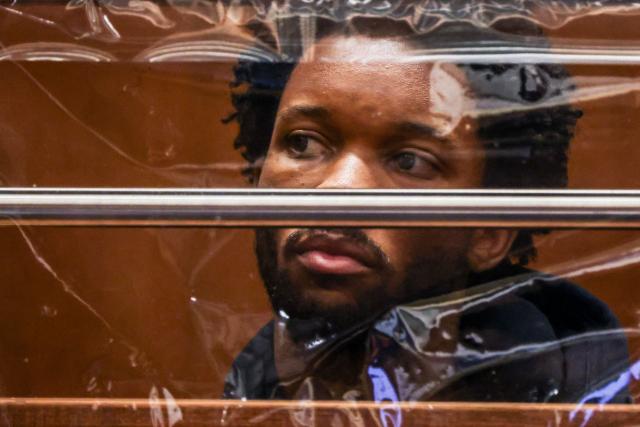 US singer D4vd is seen during his arraignment at Clara Shortridge Foltz Criminal Justice Center in Los Angeles, on April 20, 2026. Singer D4vd was charged Monday with the murder and dismemberment of a teenage girl whose decomposing body was found in an abandoned Tesla in the Hollywood Hills. The 21-year-old, whose real name is David Anthony Burke, appeared in court Monday to face multiple charges over the horrifying death of Celeste Rivas Hernandez, whose body was found in September, within days of what would have been her 15th birthday. (Photo by Ted Soqui / POOL / AFP)