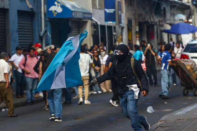 A demonstrator waves a Honduran flag during a protest against budget cuts to university education near the National Congress in Tegucigalpa on April 20, 2026. (Photo by Johny MAGALLANES / AFP)