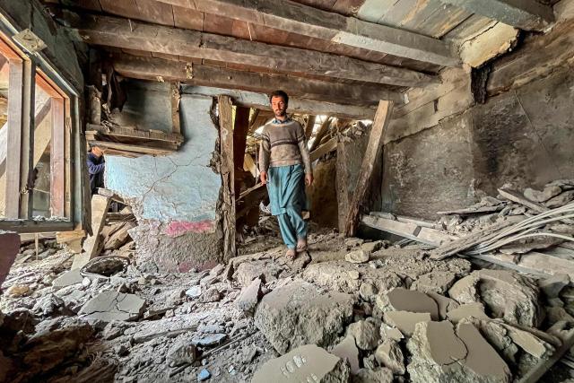(FILES) A resident walks over the debris of his damaged house owing to cross-border shelling along the Line of Control (LoC) between Pakistan and India, at Jura sector in the Neelum Valley of Pakistan-administered Kashmir on May 10, 2025. Relations between nuclear-armed neighbours India and Pakistan plummeted last year in 2025 after an April 22 attack in Indian-administered Kashmir killed 26 men, mostly Hindu tourists, leading to their worst conflict in decades -- triggering tit-for-tat diplomatic measures and a sharp military escalation that killed more than 70 people on both sides. (Photo by Muzammil AHMED / AFP)