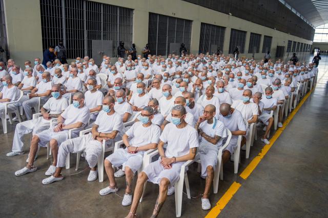 This handout photo released by the El Salvador Attorney General's Office on April 20, 2026, shows alleged members of the Mara Salvatrucha (MS-13) during a remote court hearing via video link from the Counter-Terrorism Confinement Center (CECOT) mega-prison in Tecoluca, El Salvador. Around 490 alleged members of the powerful Central American gang Mara Salvatrucha (MS-13), including its leaders, have gone on trial collectively in El Salvador, the Attorney General's office and courts said on April 20. (Photo by Handout / El Salvador Attorney General's Office / AFP)