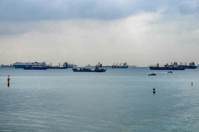 This picture shows vessels anchored along the Singapore straits eastern anchorage in Singapore on April 21, 2026. (Photo by Roslan RAHMAN / AFP)