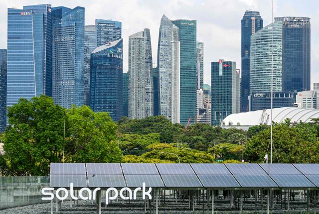 Solar panels are seen on the rooftop of the Marina barrage in Singapore on April 21, 2026. (Photo by Roslan RAHMAN / AFP)