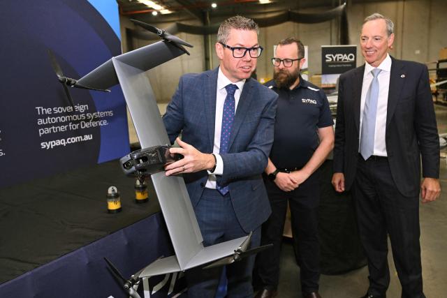 Australia's Minister for Defence Industry Pat Conroy (L) inspects a drone interceptor as the Australian Government announces it will invest 5 billion USD over the next decade in counter drones for the Australian Defence Force (ADF), in Melbourne on April 21, 2026 (Photo by William WEST / AFP)