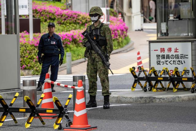 A Japan Ground Self-Defence Force (JGSDF) soldier stands guard at the Ministry of Defence in Tokyo on April 21, 2026. (Photo by Yuichi YAMAZAKI / AFP)