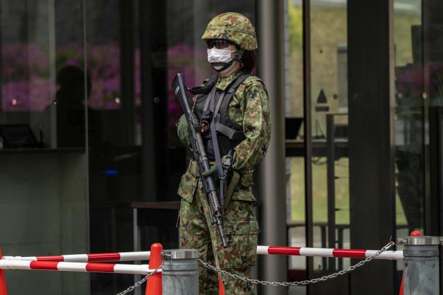 A Japan Ground Self-Defence Force (JGSDF) soldier stands guard at the Ministry of Defence in Tokyo on April 21, 2026. (Photo by Yuichi YAMAZAKI / AFP)