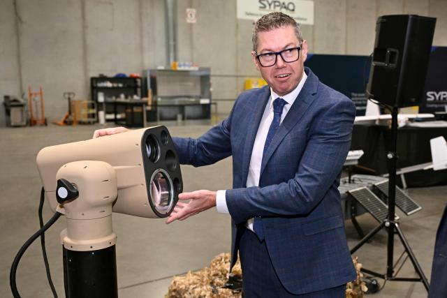 Australia's Minister for Defence Industry Pat Conroy inspects a AIM Defence Fractl:1 counter-drone laser system as the Australian Government announces it will invest 5 billion USD over the next decade in counter drones for the Australian Defence Force (ADF), in Melbourne on April 21, 2026 (Photo by William WEST / AFP)