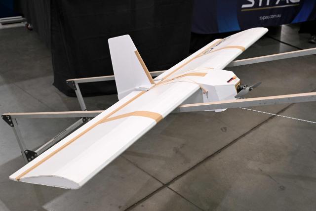 A cardboard drone is displayed as the Australian Government announces it will invest 5 billion USD over the next decade in counter drones for the Australian Defence Force (ADF), in Melbourne on April 21, 2026 (Photo by William WEST / AFP)