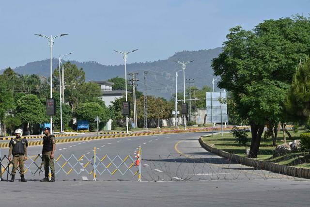 Security personnel stand guard at a checkpoint near the Serena Hotel at the Red Zone area in Islamabad on April 21, 2026, amid heightened security measures ahead of US-Iran peace talks. Pakistan's Prime Minister Shehbaz Sharif said on April 19 he had spoken by phone with Iranian President Masoud Pezeshkian ahead of anticipated US-Iran talks in Islamabad, and reaffirmed his government's readiness to mediate the conflict. US President Donald Trump is sending negotiators to Pakistan on April 20 for talks with Iran just days before a ceasefire in the Middle East expires, though Tehran has reportedly yet to decide whether it will participate. (Photo by Asif HASSAN / AFP)