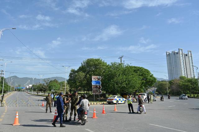 Security personnel stand guard at a checkpoint near the Serena Hotel at the Red Zone area in Islamabad on April 21, 2026, amid heightened security measures ahead of US-Iran peace talks. Pakistan's Prime Minister Shehbaz Sharif said on April 19 he had spoken by phone with Iranian President Masoud Pezeshkian ahead of anticipated US-Iran talks in Islamabad, and reaffirmed his government's readiness to mediate the conflict. US President Donald Trump is sending negotiators to Pakistan on April 20 for talks with Iran just days before a ceasefire in the Middle East expires, though Tehran has reportedly yet to decide whether it will participate. (Photo by Asif HASSAN / AFP)