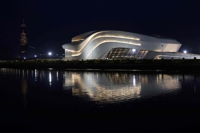 A night view of the Mohammed VI Tower (L), the tallest tower in Morocco, approximately 250 meters and comprising ofy 55 floors, and the Grand Theatre of Rabat, in the costal city of Rabat on April 20, 2026. (Photo by Abdel Majid BZIOUAT / AFP)