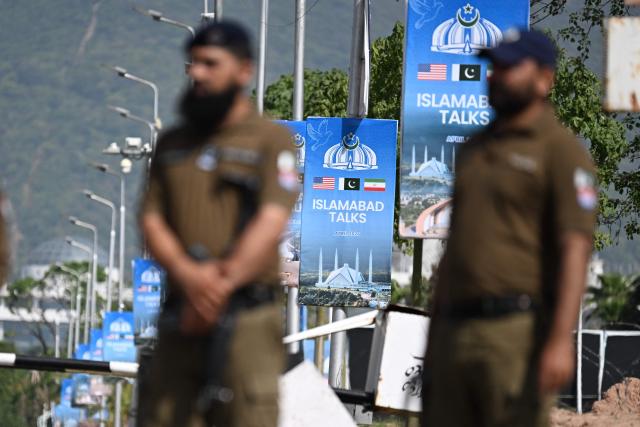 Security personnel stand guard at a checkpoint near the Serena Hotel at the Red Zone area in Islamabad on April 21, 2026, amid heightened security measures ahead of US-Iran peace talks. Pakistan's Prime Minister Shehbaz Sharif said on April 19 he had spoken by phone with Iranian President Masoud Pezeshkian ahead of anticipated US-Iran talks in Islamabad, and reaffirmed his government's readiness to mediate the conflict. US President Donald Trump is sending negotiators to Pakistan on April 20 for talks with Iran just days before a ceasefire in the Middle East expires, though Tehran has reportedly yet to decide whether it will participate. (Photo by Aamir QURESHI / AFP)