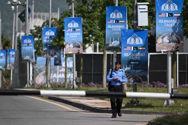 A security personnel walks along a closed road near the Serena Hotel at the Red Zone area in Islamabad on April 21, 2026, amid heightened security measures ahead of US-Iran peace talks. Pakistan's Prime Minister Shehbaz Sharif said on April 19 he had spoken by phone with Iranian President Masoud Pezeshkian ahead of anticipated US-Iran talks in Islamabad, and reaffirmed his government's readiness to mediate the conflict. US President Donald Trump is sending negotiators to Pakistan on April 20 for talks with Iran just days before a ceasefire in the Middle East expires, though Tehran has reportedly yet to decide whether it will participate. (Photo by Aamir QURESHI / AFP)