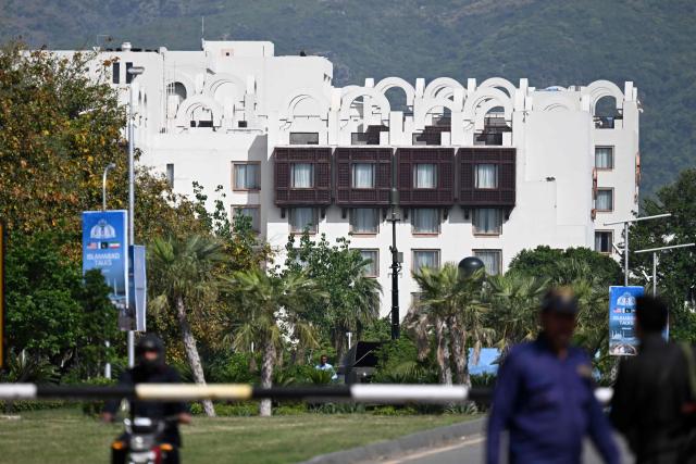 Police personnel stand guard near the Serena Hotel at the Red Zone area in Islamabad on April 21, 2026, amid heightened security measures ahead of US-Iran peace talks. Pakistan's Prime Minister Shehbaz Sharif said on April 19 he had spoken by phone with Iranian President Masoud Pezeshkian ahead of anticipated US-Iran talks in Islamabad, and reaffirmed his government's readiness to mediate the conflict. US President Donald Trump is sending negotiators to Pakistan on April 20 for talks with Iran just days before a ceasefire in the Middle East expires, though Tehran has reportedly yet to decide whether it will participate. (Photo by Aamir QURESHI / AFP)