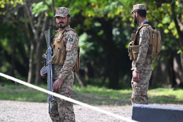 Army personnel stand guard along a closed road near the Serena Hotel at the Red Zone area in Islamabad on April 21, 2026, amid heightened security measures ahead of US-Iran peace talks. Pakistan's Prime Minister Shehbaz Sharif said on April 19 he had spoken by phone with Iranian President Masoud Pezeshkian ahead of anticipated US-Iran talks in Islamabad, and reaffirmed his government's readiness to mediate the conflict. US President Donald Trump is sending negotiators to Pakistan on April 20 for talks with Iran just days before a ceasefire in the Middle East expires, though Tehran has reportedly yet to decide whether it will participate. (Photo by Aamir QURESHI / AFP)