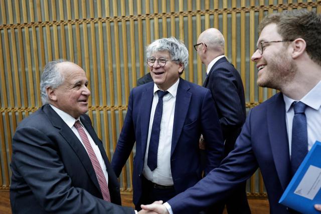 France’s junior Minister for Public Accounts David Amiel (R) greets Les Democrates' MP Jean-Paul Mattei (L) next to La France Insoumise - Nouveau Front Populaire's MP and Chair of the Finance Committee of the National Assembly Eric Coquerel (C) ahead of the public finances alert committee at the Ministry of Economics and Finance in Paris on April 21, 2026. (Photo by STEPHANE DE SAKUTIN / AFP)