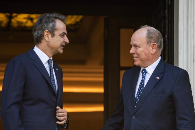 Greece's Prime Minister Kyriakos Mitsotakis (L) welcomes Prince of Monaco Albert II before their meeting in Athens on April 21, 2026. (Photo by Aris MESSINIS / AFP)
