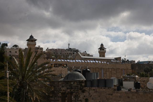 Israeli flags adorn the Ibrahimi Mosque, a holy site known to Jews as the Tombs of the Patriarchs, as Israel marks Remembrance Day, commemorating fallen Israeli soldiers, in the Israeli-occupied Palestinian West Bank city of Hebron on April 21, 2026. (Photo by HAZEM BADER / AFP)