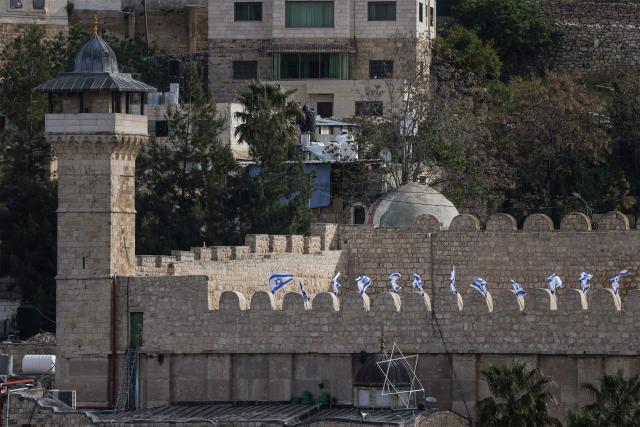 Israeli flags adorn the Ibrahimi Mosque, a holy site known to Jews as the Tombs of the Patriarchs, as Israel marks Remembrance Day, commemorating fallen Israeli soldiers, in the Israeli-occupied Palestinian West Bank city of Hebron on April 21, 2026. (Photo by HAZEM BADER / AFP)