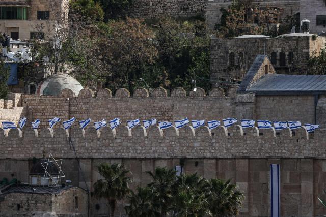 Israeli flags adorn the Ibrahimi Mosque, a holy site known to Jews as the Tombs of the Patriarchs, as Israel marks Remembrance Day, commemorating fallen Israeli soldiers, in the Israeli-occupied Palestinian West Bank city of Hebron on April 21, 2026. (Photo by HAZEM BADER / AFP)