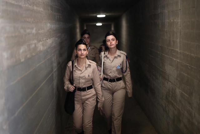 Israeli military arrive at the Military Cemetery on Mount Herzl as people gather to commemorate Israel's Remembrance Day for fallen soldiers or Yom HaZikaron, in Jerusalem on April 21, 2026. (Photo by Ilia YEFIMOVICH / AFP)