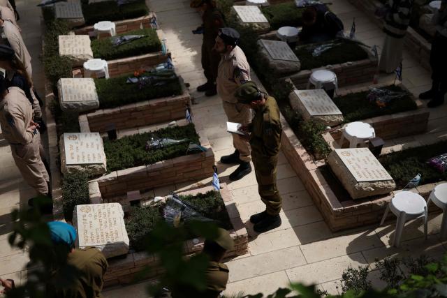 Israelis gather at the Military Cemetery on Mount Herzl commemorating Israel's Remembrance Day for fallen soldiers or Yom HaZikaron, in Jerusalem on April 21, 2026. (Photo by Ilia YEFIMOVICH / AFP)