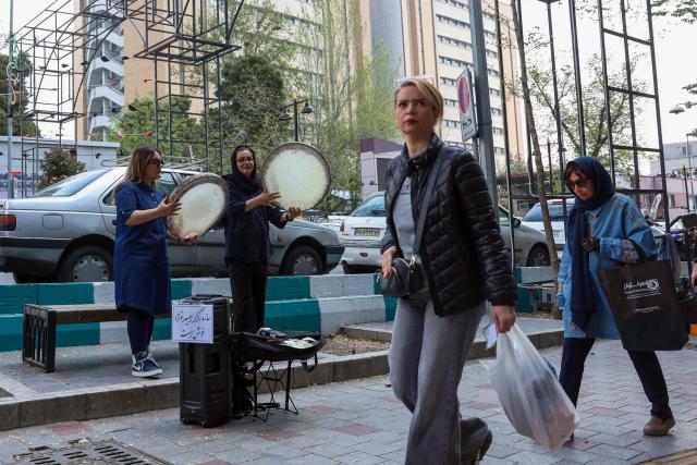Musicians perform on a street in Tehran on April 21, 2026, amid a ceasefire in the region. With the end of a two-week ceasefire approaching, the White House said US Vice President JD Vance was ready to return to Pakistan for fresh negotiations to end a conflict that has sent crude soaring and revived inflation fears. (Photo by AFP) / 
