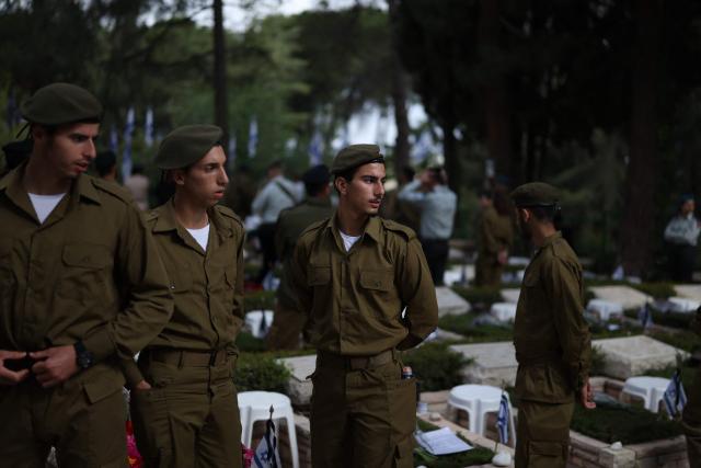 Israelis gather at the Military Cemetery on Mount Herzl commemorating Israel's Remembrance Day for fallen soldiers or Yom HaZikaron, in Jerusalem on April 21, 2026. (Photo by Ilia YEFIMOVICH / AFP)