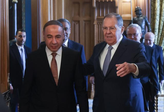 Russian Foreign Minister Sergei Lavrov and Libya's acting Foreign Minister Taher al-Baour enter a hall during their meeting at Zinaida Morozova's Mansion in Moscow on April 21, 2026. (Photo by MAXIM SHIPENKOV / POOL / AFP)