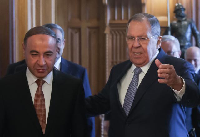 Russian Foreign Minister Sergei Lavrov and Libya's acting Foreign Minister Taher al-Baour enter a hall during their meeting at Zinaida Morozova's Mansion in Moscow on April 21, 2026. (Photo by MAXIM SHIPENKOV / POOL / AFP)