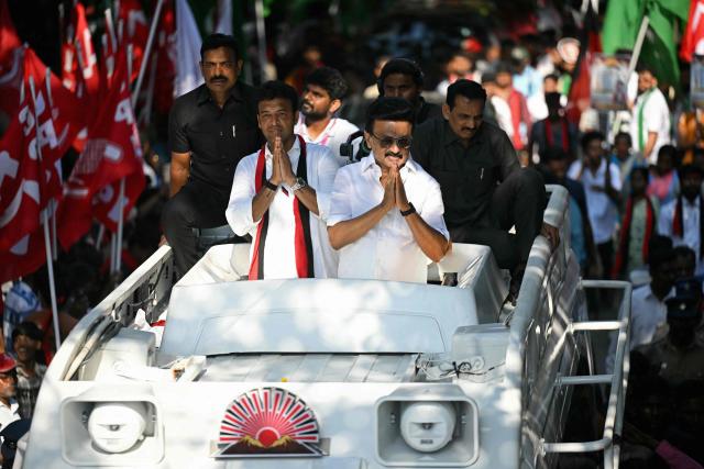 Tamil Nadu chief minister and Dravida Munnetra Kazhagam (DMK) party president MK Stalin (centre R) gestures to supporters during a road show as part of an election campaign ahead of the 2026 Tamil Nadu Legislative Assembly elections in Chennai on April 21, 2026. (Photo by R. Satish BABU / AFP)