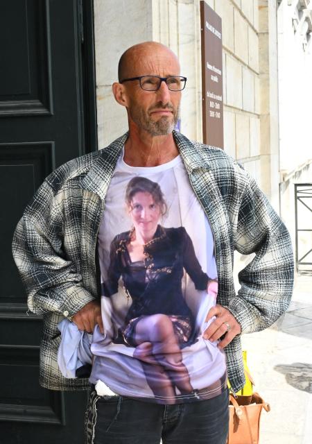 Agnes Lassalle's partner Stephane Voirin poses for the press at the entrance of the Pau courthouse as he wears a t-shirt honouring his late wife on the first day of the trial of her murderer in Pau, south-western France on April 21, 2026. The trial of the student accused of murdering Agnes Lassalle, a Spanish teacher stabbed to death in her classroom in 2023 in Saint-Jean-de-Luz, opened on April 21, 2026, behind closed doors before the juvenile assize court of the Pyrenees-Atlantiques, as judges examine in particular the criminal responsibility of the accused. (Photo by Gaizka IROZ / AFP)