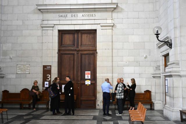 Agnes Lassalle's partner Stephane Voirin (R) talks to lawyers  at the entrance of the Pau courthouse on the first day of the trial of her murderer in Pau, south-western France on April 21, 2026. The trial of the student accused of murdering Agnes Lassalle, a Spanish teacher stabbed to death in her classroom in 2023 in Saint-Jean-de-Luz, opened on April 21, 2026, behind closed doors before the juvenile assize court of the Pyrenees-Atlantiques, as judges examine in particular the criminal responsibility of the accused. (Photo by Gaizka IROZ / AFP)