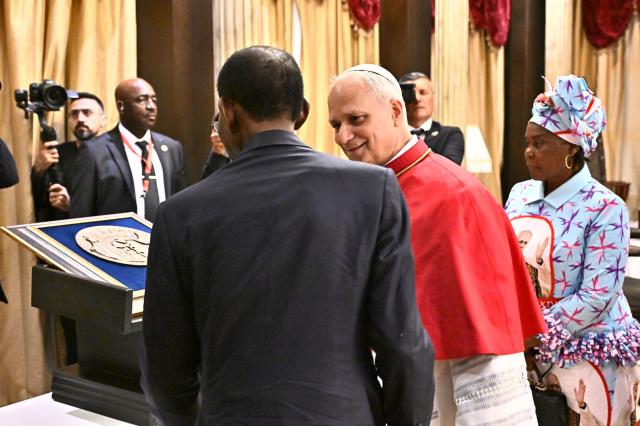 Pope Leo XIV (CR) meets with Equatorial Guinea's President Teodoro Obiang Nguema Mbasogo (CR) at the Presidential Palace in Malabo on the ninth day of an 11-day apostolic journey to Africa, on April 21, 2026. (Photo by LUCA ZENNARO / POOL / AFP)