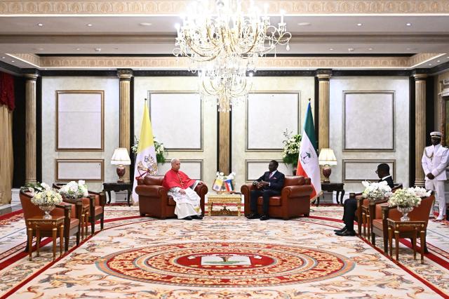Pope Leo XIV (L) meets with Equatorial Guinea's President Teodoro Obiang Nguema Mbasogo (C) at the Presidential Palace in Malabo on the ninth day of an 11-day apostolic journey to Africa, on April 21, 2026. (Photo by LUCA ZENNARO / POOL / AFP)