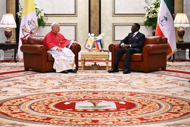 Pope Leo XIV (L) meets with Equatorial Guinea's President Teodoro Obiang Nguema Mbasogo (R) at the Presidential Palace in Malabo on the ninth day of an 11-day apostolic journey to Africa, on April 21, 2026. (Photo by LUCA ZENNARO / POOL / AFP)