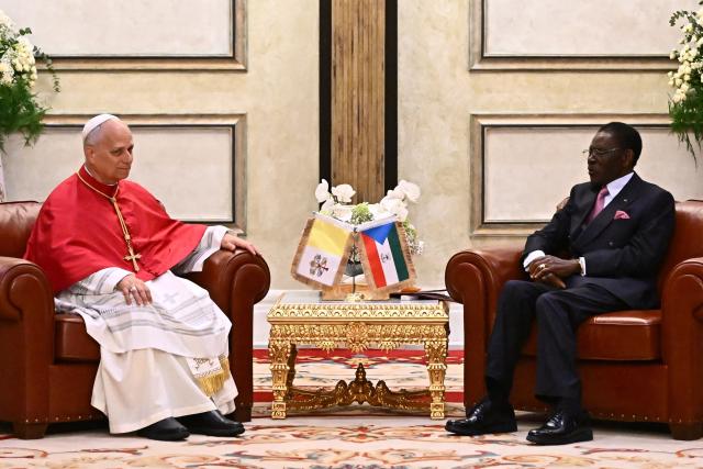 Pope Leo XIV (L) meets with Equatorial Guinea's President Teodoro Obiang Nguema Mbasogo (R) at the Presidential Palace in Malabo on the ninth day of an 11-day apostolic journey to Africa, on April 21, 2026. (Photo by LUCA ZENNARO / POOL / AFP)