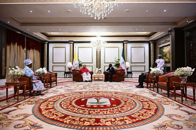 Pope Leo XIV (CL) meets with Equatorial Guinea's President Teodoro Obiang Nguema Mbasogo (CR) at the Presidential Palace in Malabo on the ninth day of an 11-day apostolic journey to Africa, on April 21, 2026. (Photo by LUCA ZENNARO / POOL / AFP)