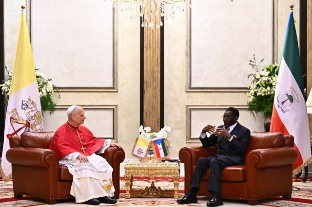 Pope Leo XIV (L) meets with Equatorial Guinea's President Teodoro Obiang Nguema Mbasogo (R) at the Presidential Palace in Malabo on the ninth day of an 11-day apostolic journey to Africa, on April 21, 2026. (Photo by LUCA ZENNARO / POOL / AFP)