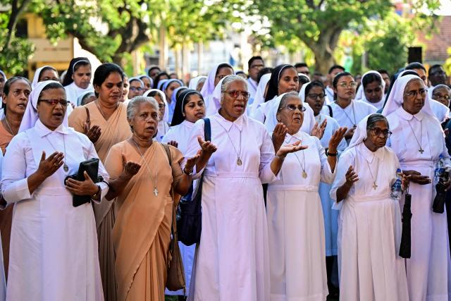 Catholic nuns pray before taking part in a silent march outside St. Sebastian’s Church in Katuwapitiya on April 21, 2026 marking the seventh anniversary of the 2019 Easter Sunday bombings. The United Nations urged Sri Lanka on April 21 to deliver concrete results after long-running investigations into the 2019 Easter Sunday suicide bombings that killed 279 people, including 45 foreigners. (Photo by Ishara S. KODIKARA / AFP)