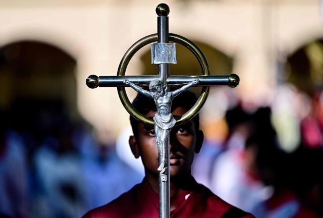 A Sri Lankan Christian altar boy takes part in a silent march outside St. Sebastian’s Church in Katuwapitiya on April 21, 2026 marking the seventh anniversary of the 2019 Easter Sunday bombings. The United Nations urged Sri Lanka on April 21 to deliver concrete results after long-running investigations into the 2019 Easter Sunday suicide bombings that killed 279 people, including 45 foreigners. (Photo by Ishara S. KODIKARA / AFP)