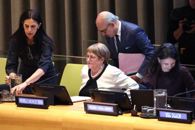 Former Chilean president Michelle Bachelet (C) arrives for a hearing to be considered as the next Secretary-General of the United Nations at the UN Headquarters in New York, on April 21, 2026. Bachelet is among four candidates vying for the position currently held by Portugal's Antonio Guterres. (Photo by TIMOTHY A. CLARY / AFP)