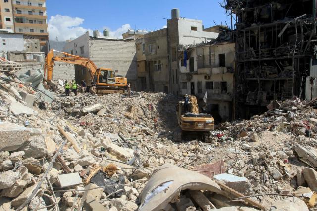 Diggers remove the rubble of buildings destroyed in Israeli strikes as they look for survivors buried underneath in the southern Lebanese coastal city of Tyre on April 21, 2026. Israeli defence minister said on April 21 that his country's campaign in Lebanon relied on both military and diplomatic pressure to disarm Iran-allied Hezbollah. Though a truce between Israel and Lebanon took effect on April 17, Israeli troops are still present and actively fighting Hezbollah militants in Lebanon's south. (Photo by Mahmoud ZAYYAT / AFP)