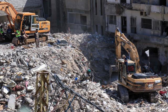 Diggers remove the rubble of buildings destroyed in Israeli strikes as they look for survivors buried underneath in the southern Lebanese coastal city of Tyre on April 21, 2026. Israeli defence minister said on April 21 that his country's campaign in Lebanon relied on both military and diplomatic pressure to disarm Iran-allied Hezbollah. Though a truce between Israel and Lebanon took effect on April 17, Israeli troops are still present and actively fighting Hezbollah militants in Lebanon's south. (Photo by Mahmoud ZAYYAT / AFP)
