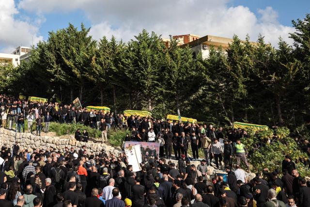 Mourners carry the coffins of Hezbollah fighters, killed before a 10-day ceasefire was agreed between the Iran-backed militant group and Israel, during a mass funeral in the southern village of Kfar Sir on April 21, 2026. Israeli defence minister said on April 21 that his country's campaign in Lebanon relied on both military and diplomatic pressure to disarm Iran-allied Hezbollah. Though a truce between Israel and Lebanon took effect on April 17, Israeli troops are still present and actively fighting Hezbollah militants in Lebanon's south. (Photo by ANWAR AMRO / AFP)