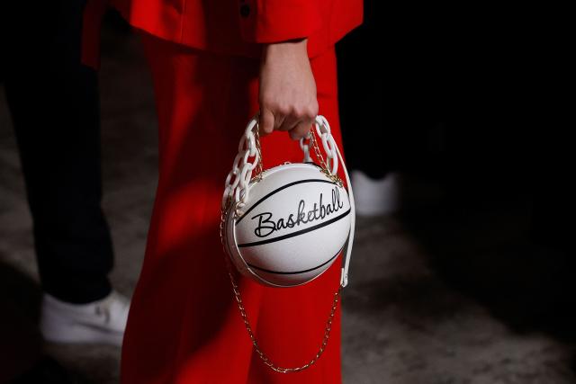 A guest with a basketball shaped handbag arrives for the FIBA Women's Basketball 2026 World Cup draw and FIBA Hall of Fame 2026 Induction ceremony in Berlin on April 21, 2026. (Photo by Odd ANDERSEN / AFP)